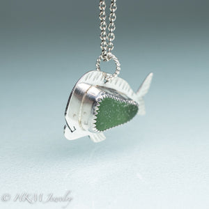 side view mahi mahi dolphin fish necklace by hkm jewelry in recycled sterling silver and serrated bezel set green sea glass piece