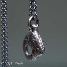 Load image into Gallery viewer, close up of stamping on hag stone necklace cast in sterling silver by hkm jewelry in oxidized finish
