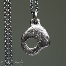 Load image into Gallery viewer, back of hag stone necklace cast in sterling silver by hkm jewelry in oxidized silver finish
