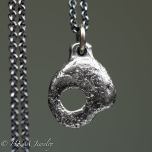 back of hag stone necklace cast in sterling silver by hkm jewelry in oxidized silver finish