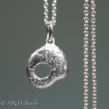 Load image into Gallery viewer, back of  hag stone necklace cast in sterling silver by hkm jewelry in polished finish
