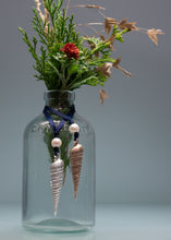 Load image into Gallery viewer, Clear glass bottle with floral arrangement and decorative elements on a gray background
