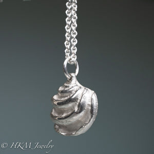 side view of ribs on Imperial Venus Clam shell necklace in recycled silver by hkm jewelry
