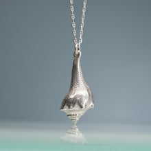 Load image into Gallery viewer, Silver pendant necklace on a reflective surface with a gradient background
