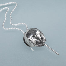 Load image into Gallery viewer, Silver horseshoe crab necklace on a chain against a light blue background
