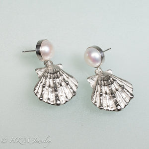 side view of cast silver lion's paw shell two tiered earrings with freshwater pearls by hkm jewelry