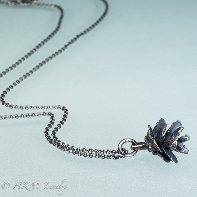 cast silver hemlock pine cone necklace by hkm jewelry in oxidized finish