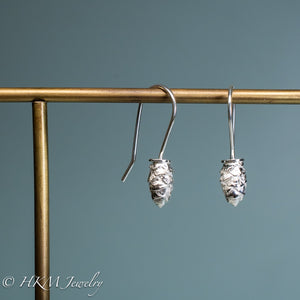 front and side view of mini cone drop earrings in polished sterling silver by hkm jewelry