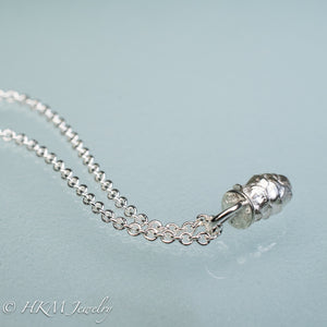 top view of cast silver mini pinecone necklace by hkm jewelry in polished  finish