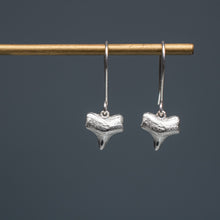 Load image into Gallery viewer, cast silver small shark tooth earrings on brass earring stand with blue gradient background
