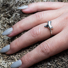 Load image into Gallery viewer, cast silver small shark tooth ring on hand model with textured beige coral background
