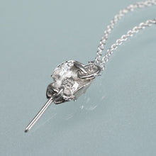 Load image into Gallery viewer, underside view of HKM makersmark and Hallmark .925 of the mini cast silver horseshoe crab necklace by hali maclaren of hkm jewelry laying on blue background
