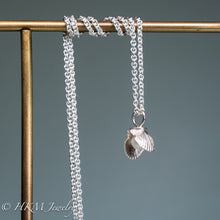 Load image into Gallery viewer, mini bay scallop necklace with pearl on brass jewelry display by hkm jewelry
