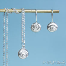 Load image into Gallery viewer, Silver jewelry set including necklaces and earrings on a blue background with 'HKM Jewelry' branding.
