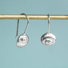Load image into Gallery viewer, Silver spiral earrings on a gold hook against a light blue background
