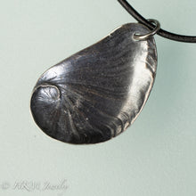Load image into Gallery viewer, Naticidae moon snail operculum cast in sterling silver on leather cord by hkm jewelry
