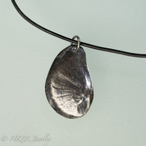 Naticidae moon snail operculum cast in sterling silver on leather cord by hkm jewelry