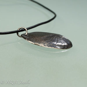 Naticidae moon snail operculum cast in sterling silver on leather cord by hkm jewelry