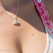 Load image into Gallery viewer, top side of silver dolphin tail necklace by hkm jewelry on model
