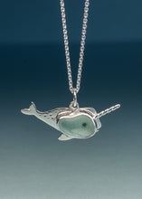 Load image into Gallery viewer, A sterling silver narwhal pendant necklace with a light green stone inlay, hanging from a silver ball chain against a dark blue gradient background.

