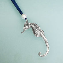 Load image into Gallery viewer, cast silver seahorse ornament with freshwater pearl and navy blue satin ribbon by hkm jewelry
