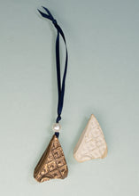Load image into Gallery viewer, Two decorative items, one gold and one beige, hanging from a blue ribbon against a light gray background.
