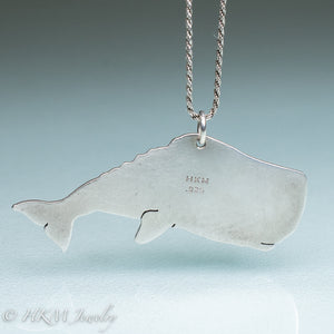 back view of sperm whale necklace by hkm jewelry in recycled sterling silver and bezel set fossil clam shell piece