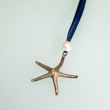 Load image into Gallery viewer, cast bronze starfish ornament with freshwater pearl and navy blue satin ribbon by hkm jewelry
