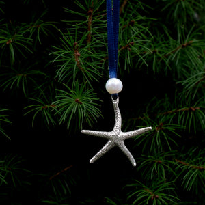 cast silver starfish ornament with freshwater pearl and navy blue satin ribbon by hkm jewelry