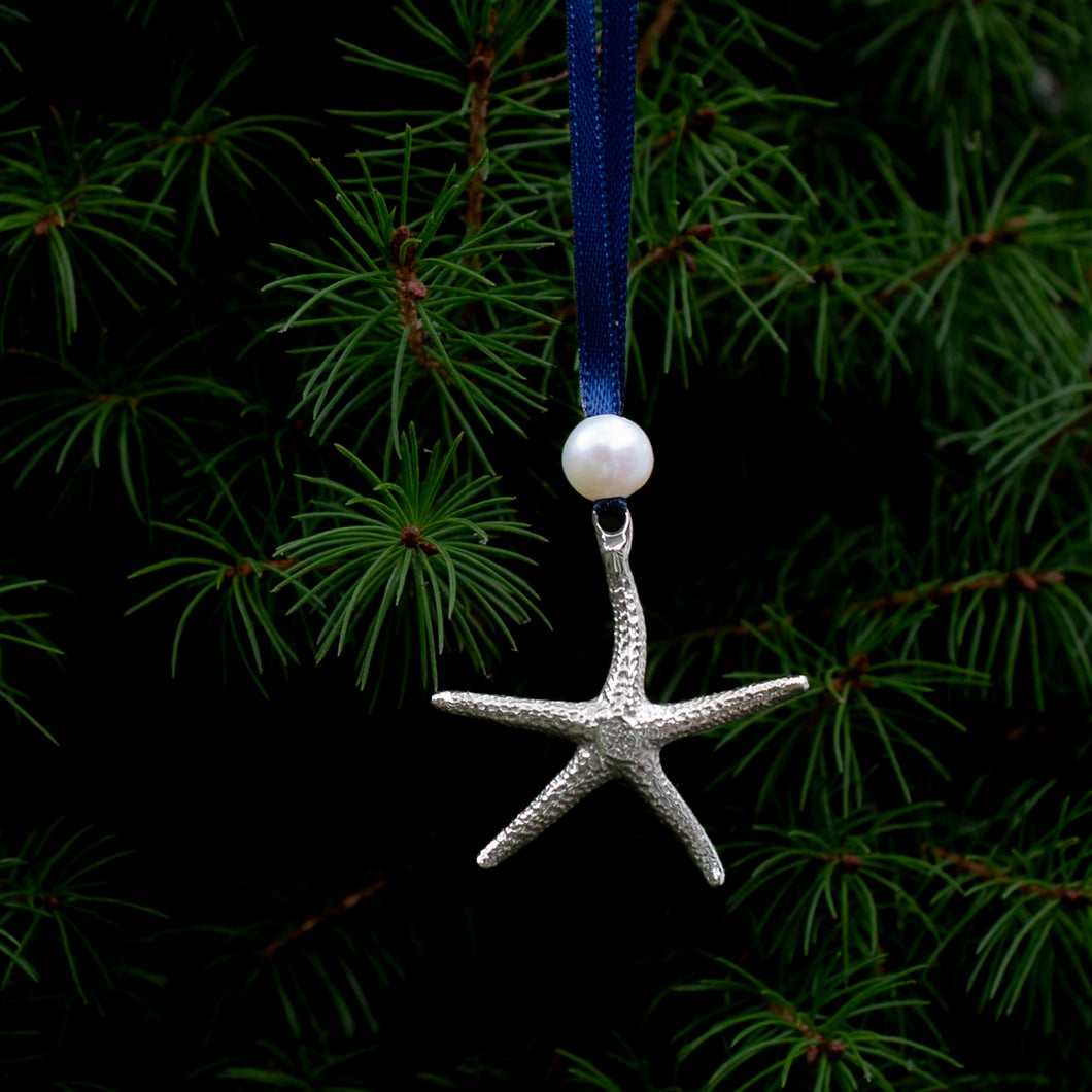 cast silver starfish ornament with freshwater pearl and navy blue satin ribbon by hkm jewelry