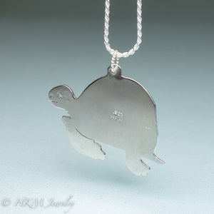 underside of hand sawn and pierced sterling silver sea turtle necklace with fossilized clam shell shard bezel setting by hkm jewelry stamped 925