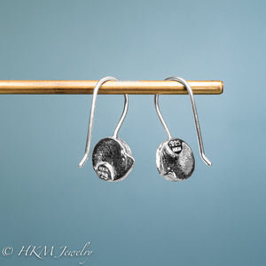 backside of hallmark .925 and HKM stamp on Whelk top drop earrings in recycled sterling silver by hkm jewelry