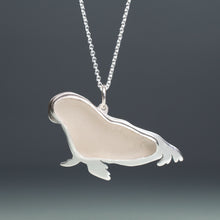 Load image into Gallery viewer, Silver sea lion pendant on a chain against a dark background
