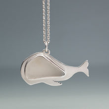 Load image into Gallery viewer, Silver whale pendant on a chain against a gray background
