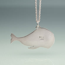 Load image into Gallery viewer, Silver whale-shaped pendant on a chain against a gradient background
