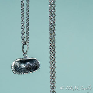 back close up view of ark clam shell necklace in oxidized silver by hkm jewelry 