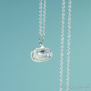 back close up view of ark clam shell necklace in polished silver by hkm jewelry 