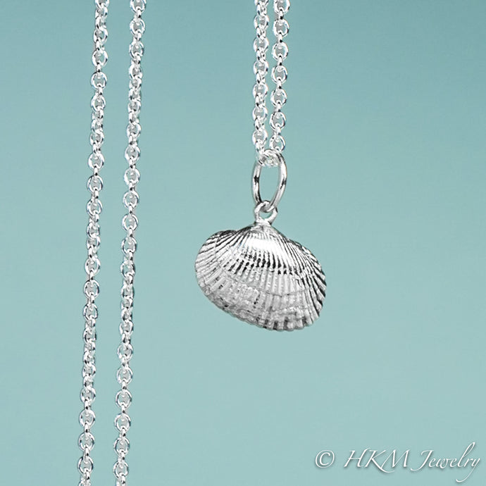 front close up view of ark clam shell necklace in polished silver by hkm jewelry 