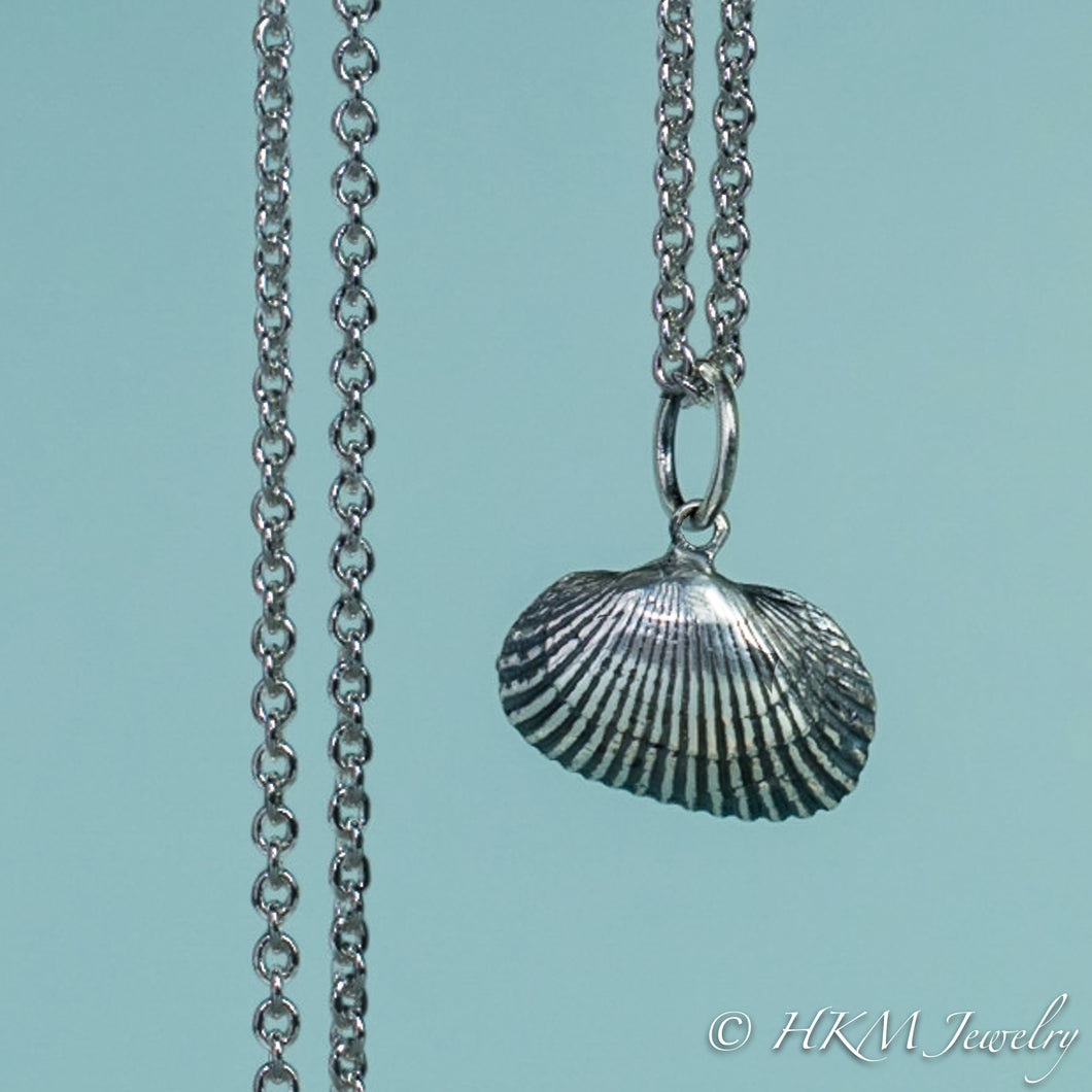 front close up view of ark clam shell necklace in oxidized silver by hkm jewelry 