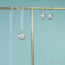 Load image into Gallery viewer, side view of ark clam seashell drop earrings in silver with matching ark clam necklace

