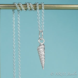 close up front view of the auger snail shell necklace in polished silver by hkm jewelry