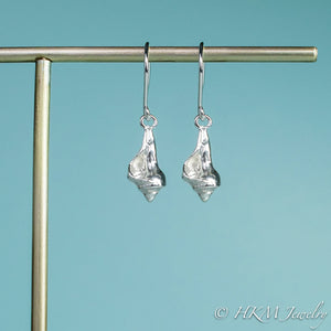 close up front view of the baby knobbed whelk dangle earrings in sterling by hkm jewelry