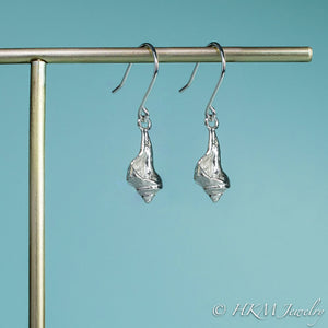 close up side view of the baby knobbed whelk dangle earrings in sterling by hkm jewelry
