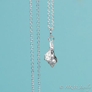 close up front view of baby knobbed whelk necklace in polished finish by hkm jewelry