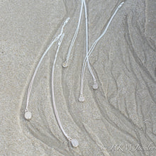 Load image into Gallery viewer, assorted raw cape may diamond necklaces by hkm jewelry laying in sand

