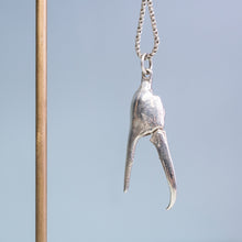 Load image into Gallery viewer, open pincer view of the cast fiddler crab claw necklace in recycled silver hanging from brass and coral necklace display on a blue background by hkm jewelry
