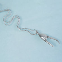 Load image into Gallery viewer, cast fiddler crab claw in recycled silver laying on a blue background by hkm jewelry

