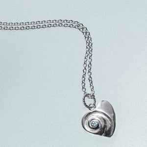 Heart of the Sea moon snail necklace by hkm jewelry with sky blue topaz december birthstone