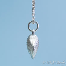 Load image into Gallery viewer, The Little Neck Clam Necklace is made from the molding and casting of a real &quot;clam seed&quot; in solid recycled silver by HKM Jewelry side view with stamping
