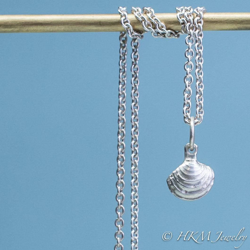 The Little Neck Clam Necklace is made from the molding and casting of a real 
